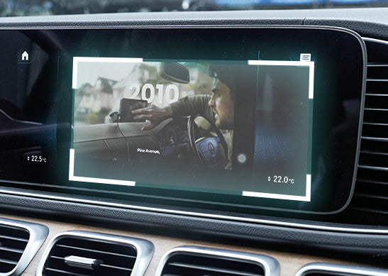 Car infotainment screen showing Ottocast wireless CarPlay adapter streaming video playback in dashboard display