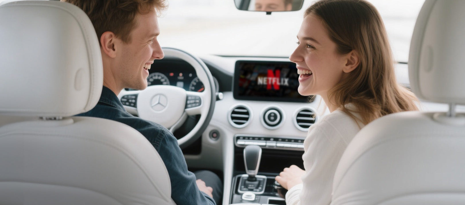 Couple enjoying Netflix streaming in car with Ottocast wireless CarPlay adapter for entertainment on the go